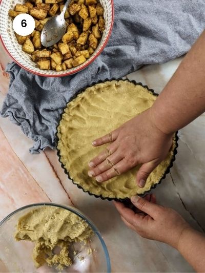 Spreading the bottom dough in the tart tin.