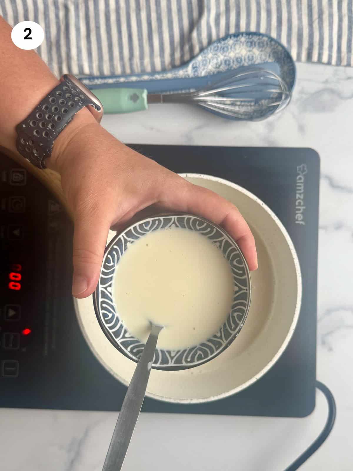 Adding cornstarch to the milk to thicken.