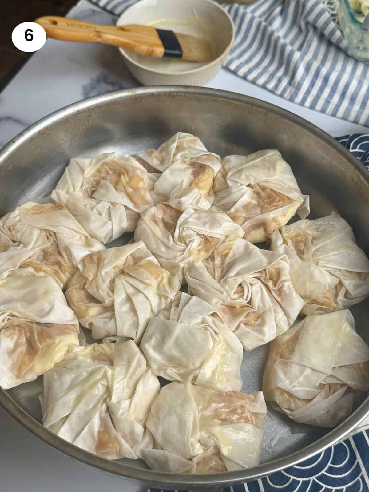 Phyllo pastries in a tray ready to go in the oven.