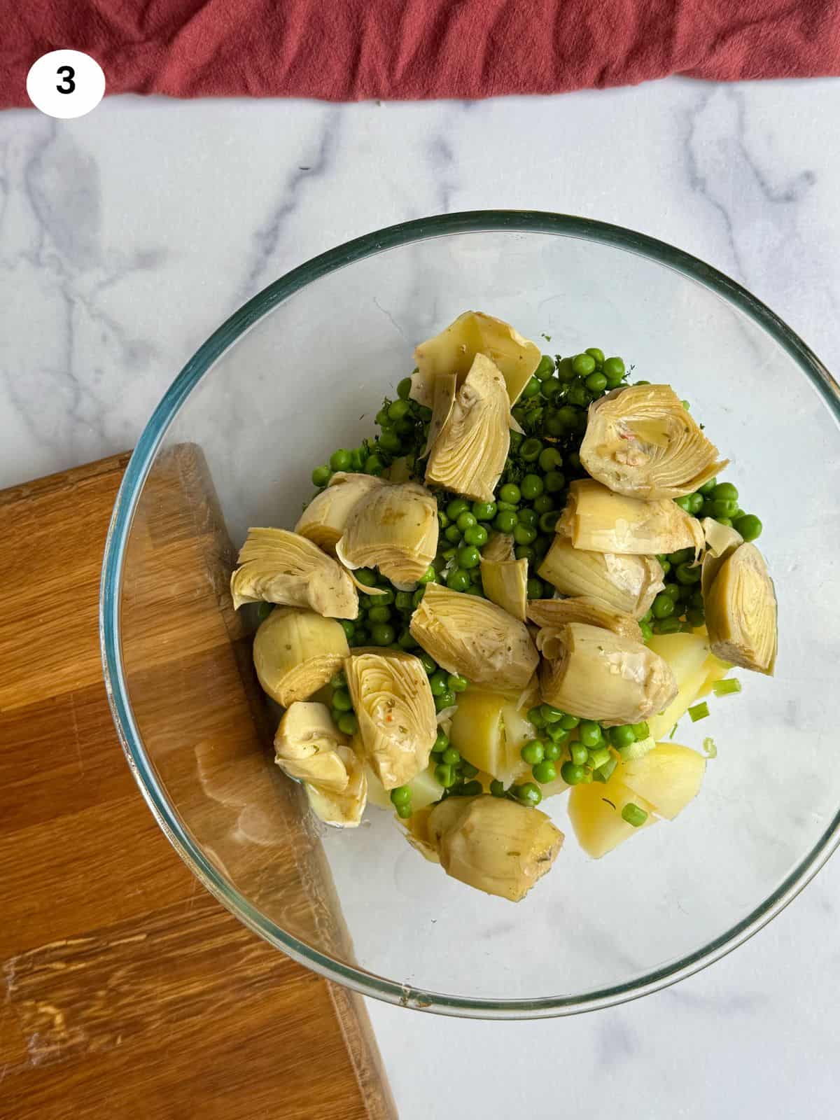 Added the marinated artichoke hearts to the bowl.