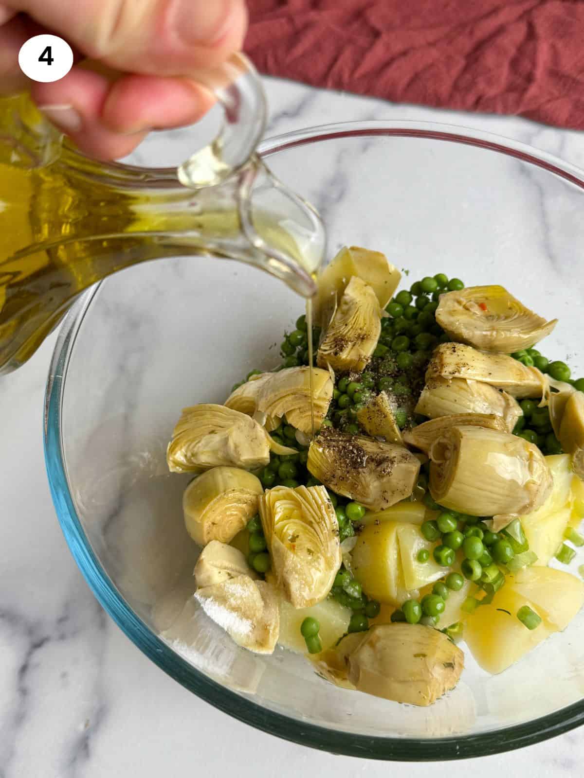 Pouring olive oil into the salad bowl.