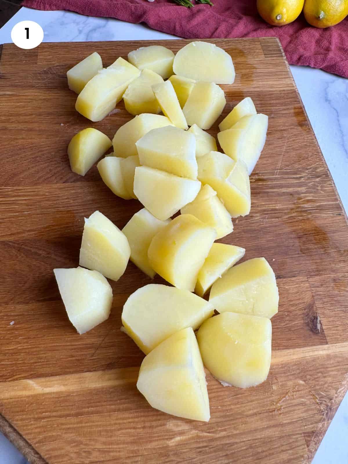 Cutting the potatoes into large chunks.