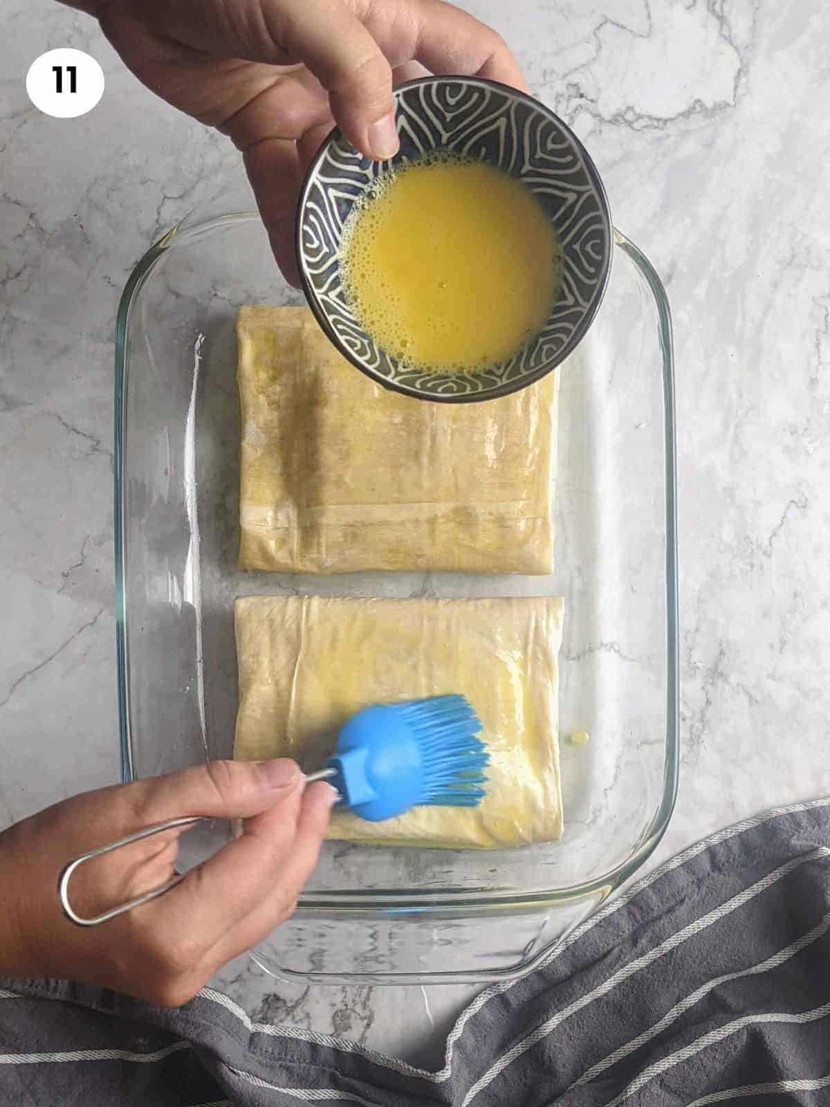 Brushing the feta parcel with egg.