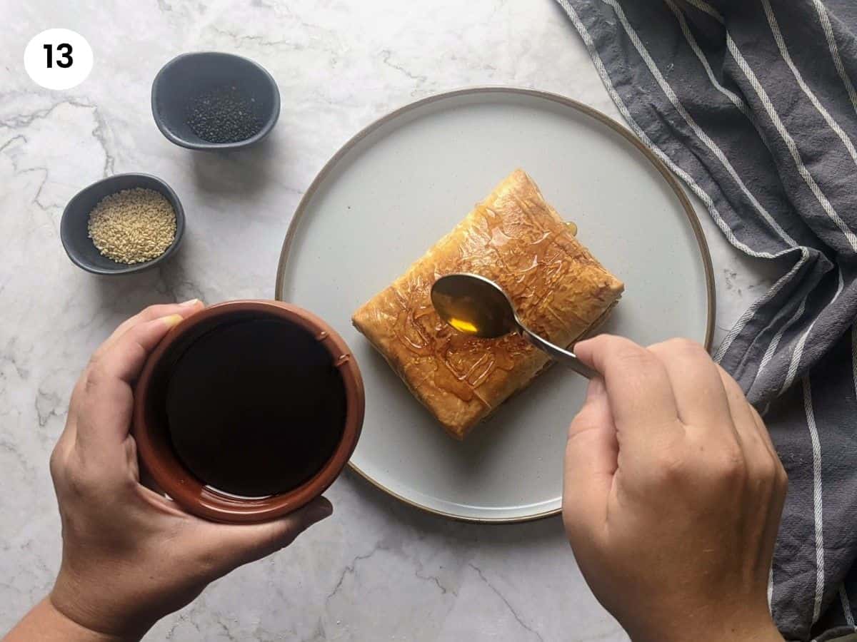 Drizzling honey on top of the feta parcel.