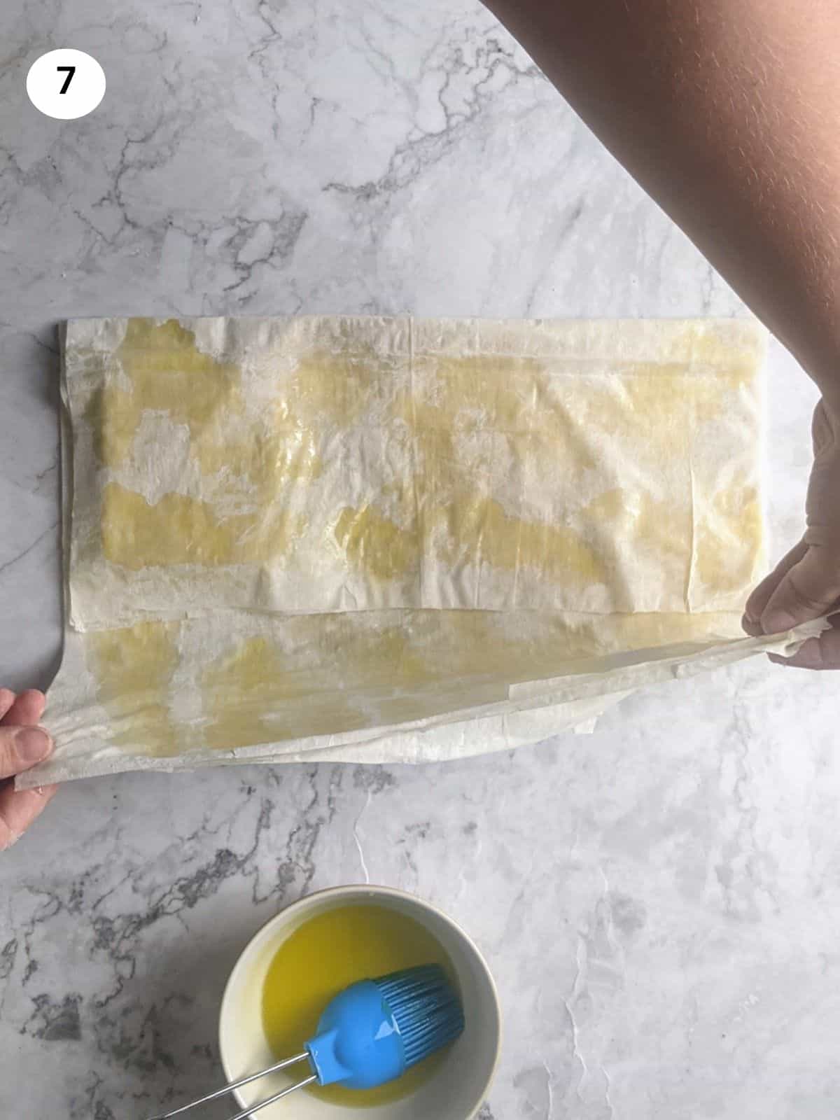 Folding the right side on top of the feta block.