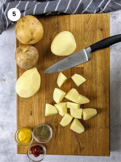 Cutting the potatoes into big wedges.