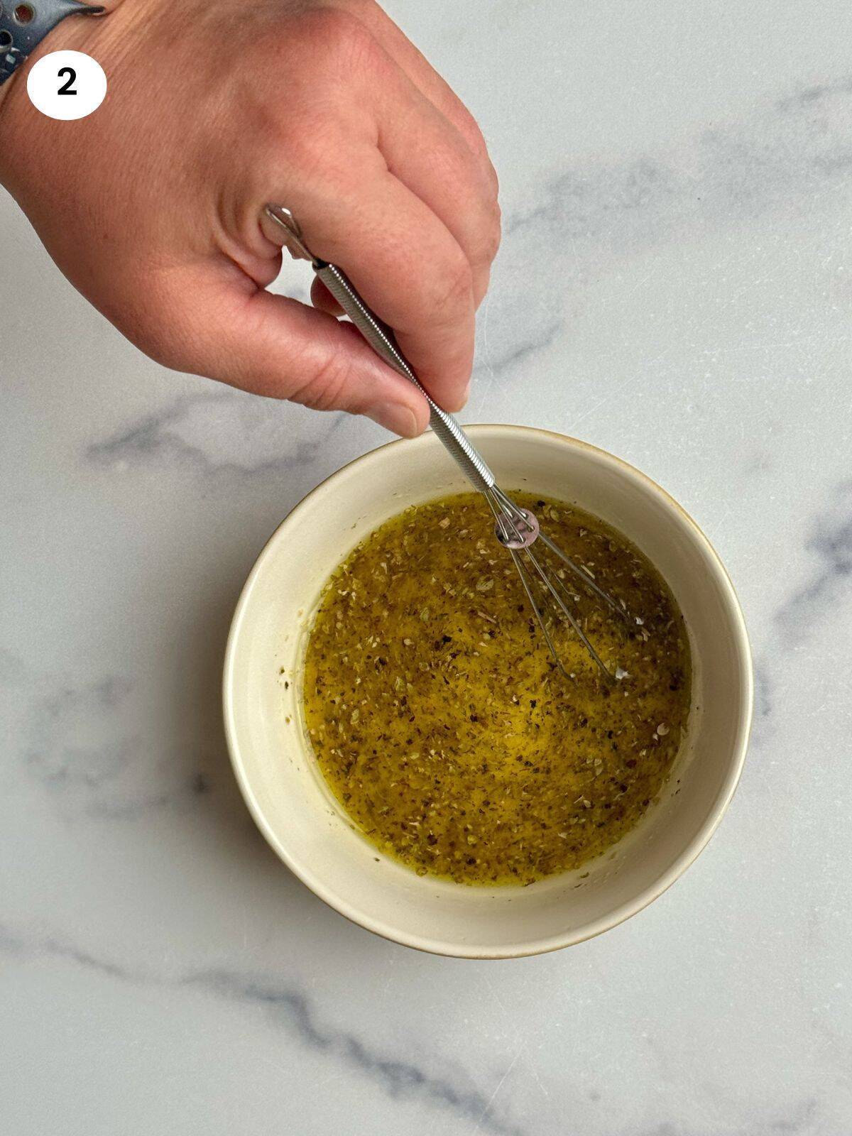 Mixing all the ingredients with a whisk.