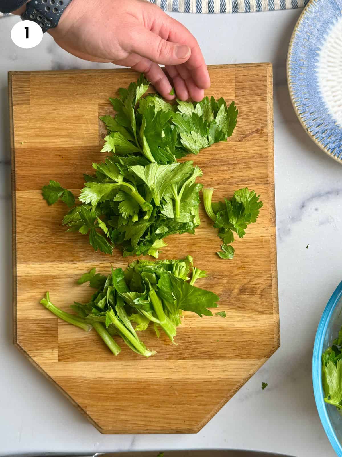 Cutting the celery greens into smaller bits
.