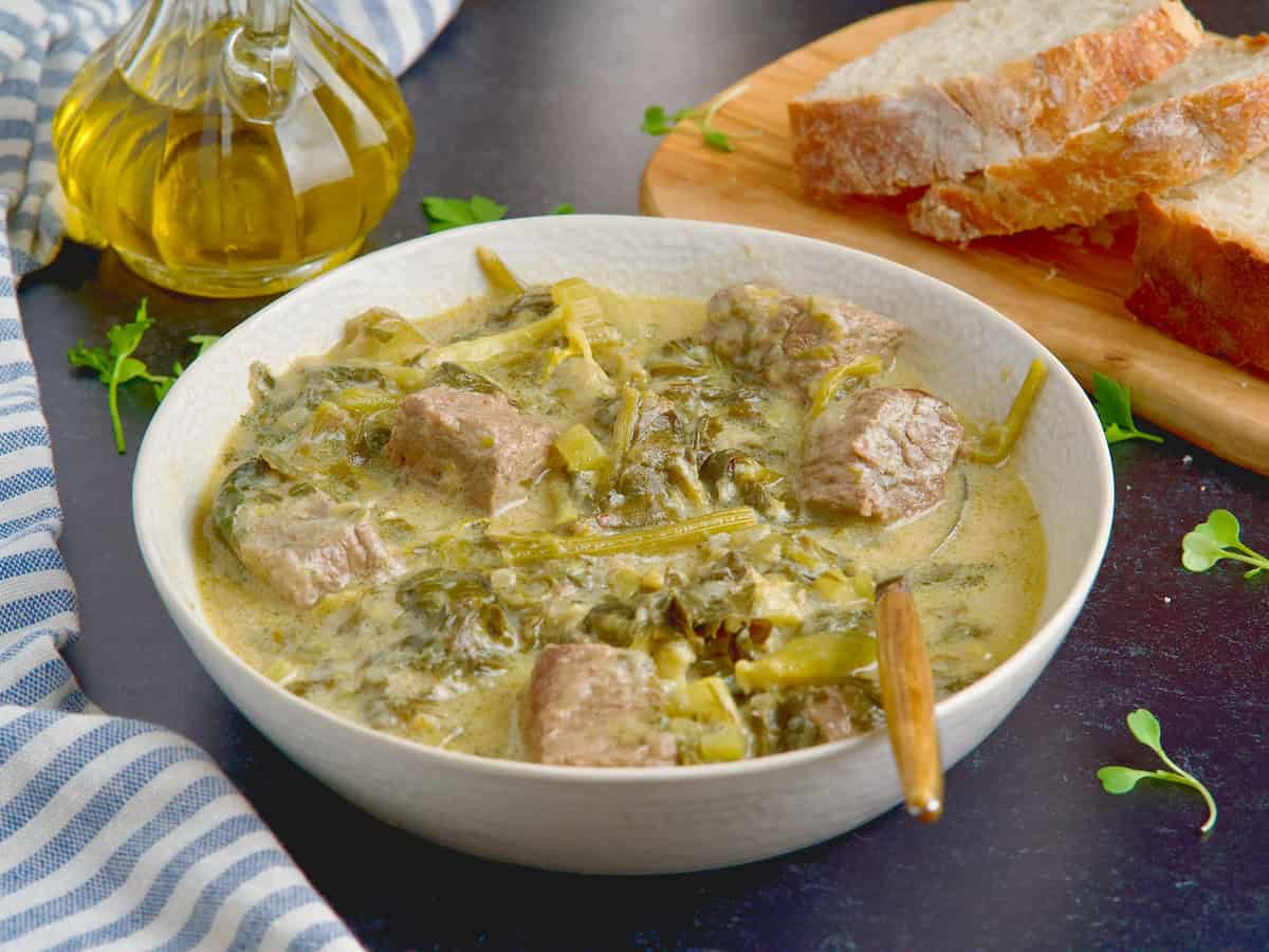 Beef celery stew served in white bowl.