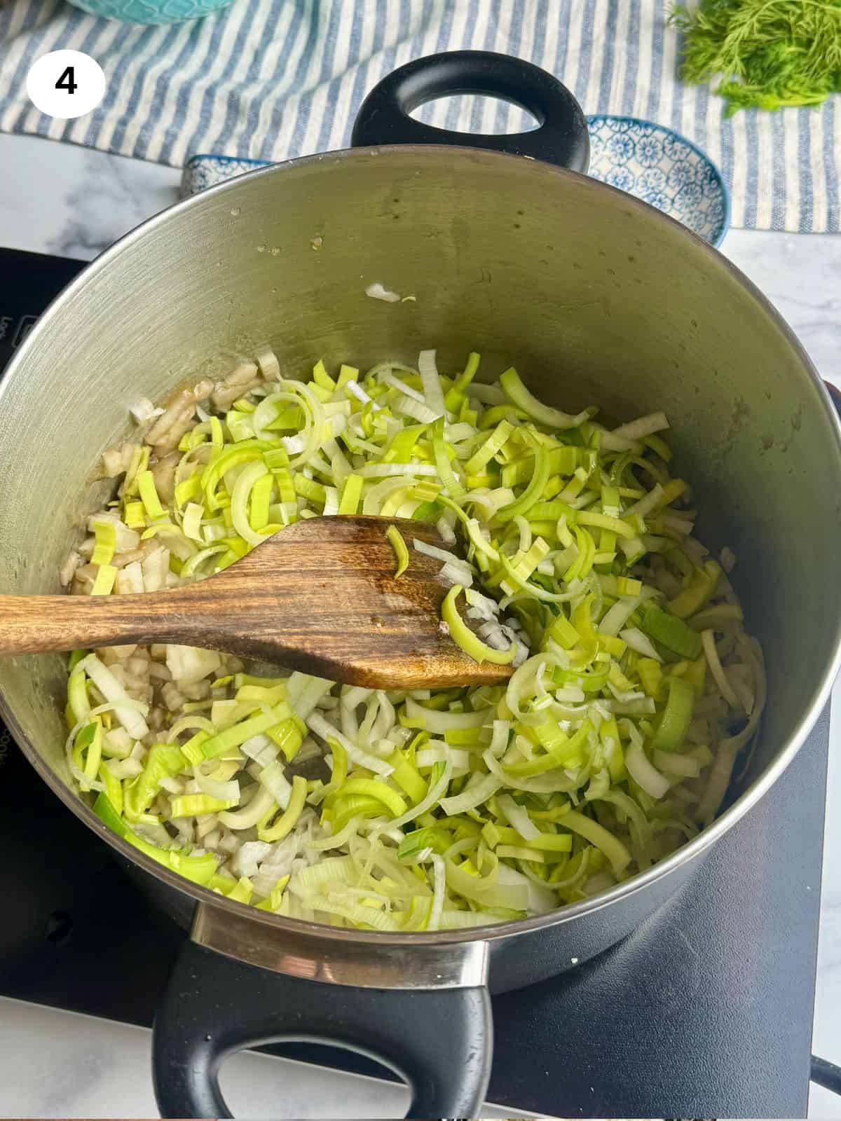 Sauteing the chopped onion and leek.