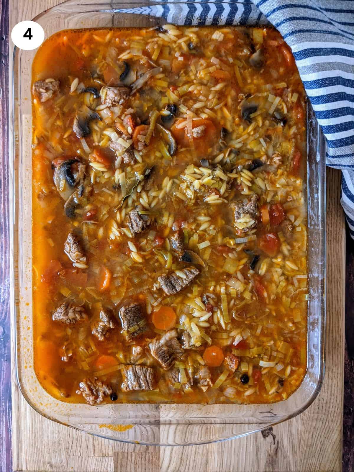 Beef and veggies with uncooked orzo.