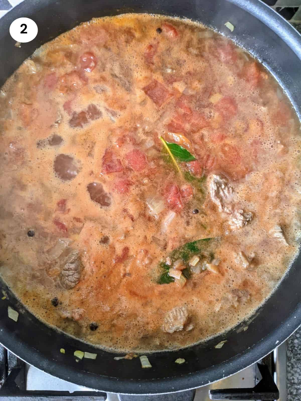 Adding the beef pieces to the pot for giouvetsi.