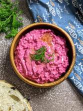 Beetroot & Yogurt Dip served with olive oil drizzled on top and dill and pitta bread on the side.