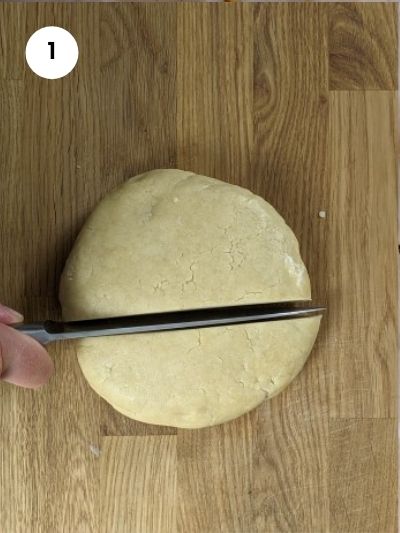 Cutting dough into two pieces.