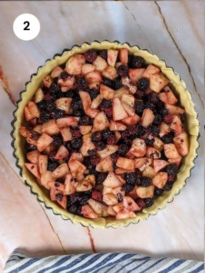 Adding filling to the pie dish.