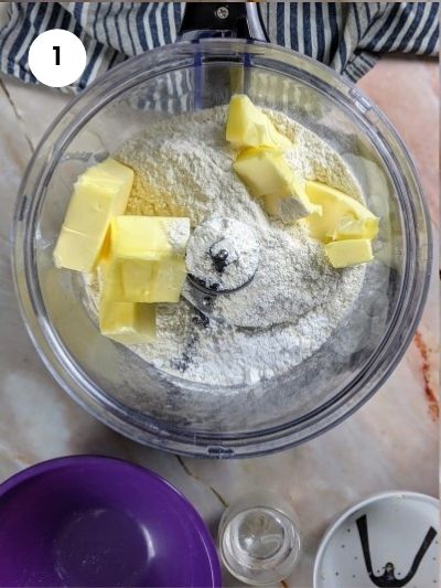 Adding the flour, powdered sugar and butter to a food processor.