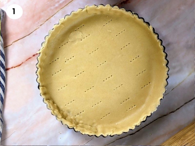 Bottom layer of pastry on the pie dish.