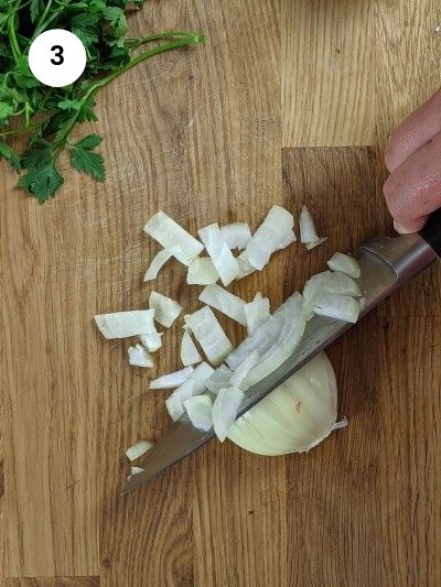 Cutting the onion into cubes for the zucchini casserole.