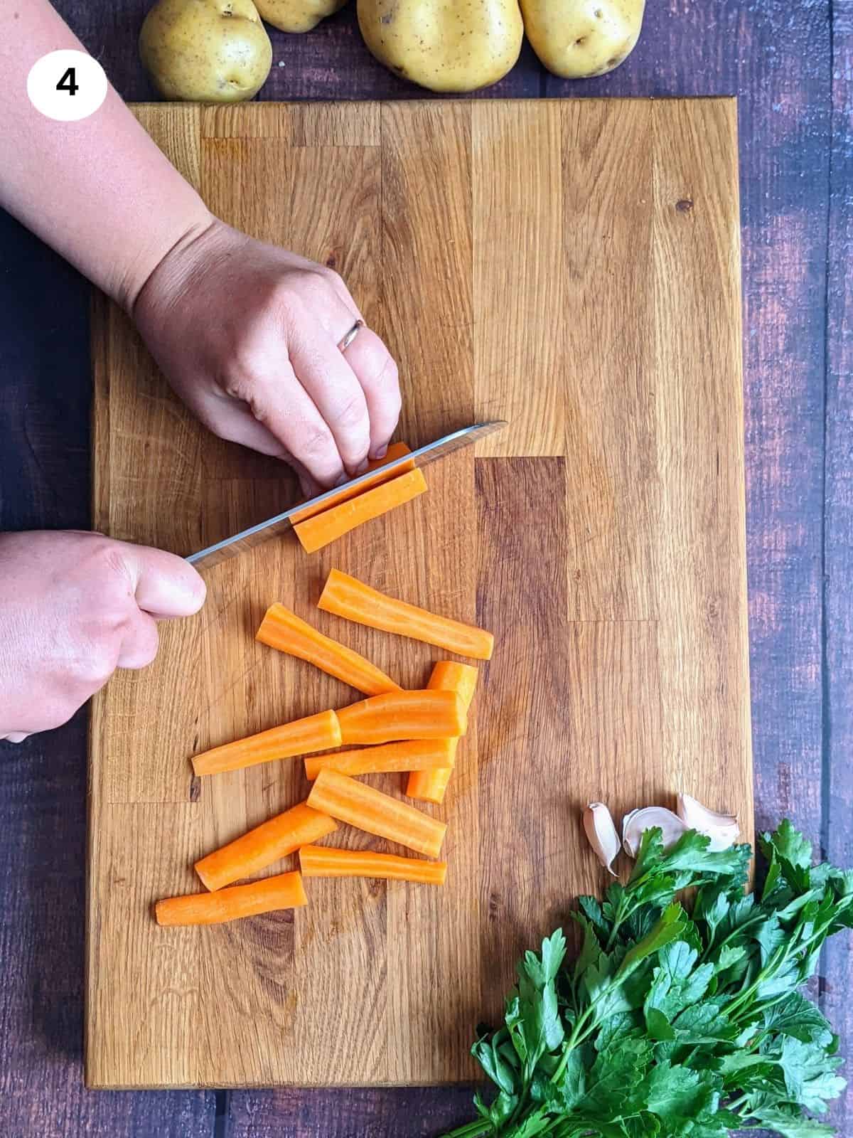 Cutting the carrots into sticks.