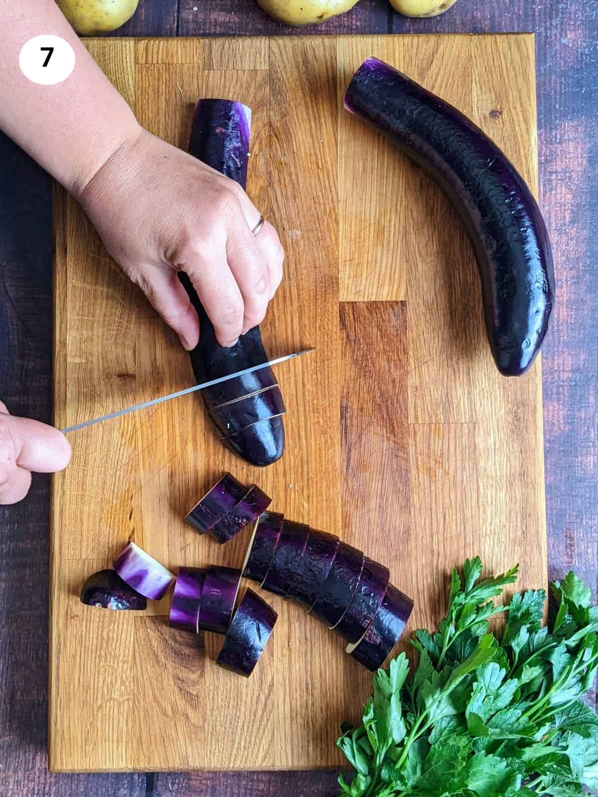 Cutting the eggplants into big chunks.