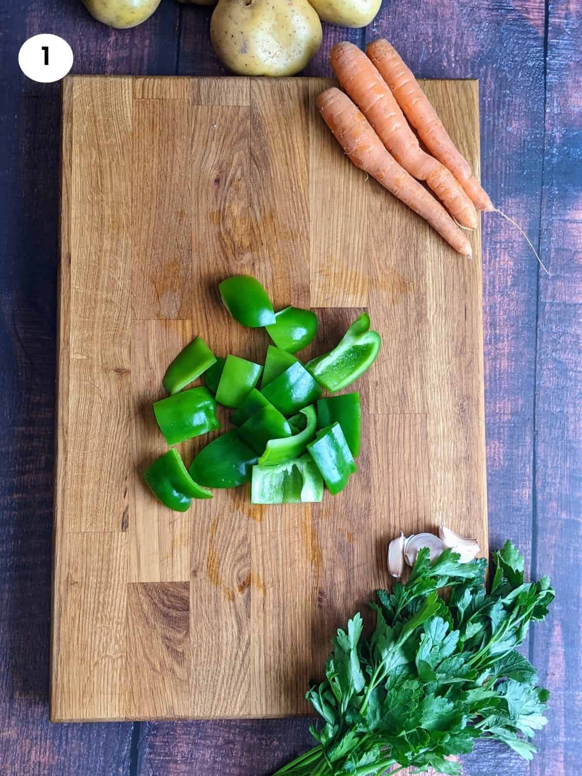 Cutting the bell pepper into chunks.