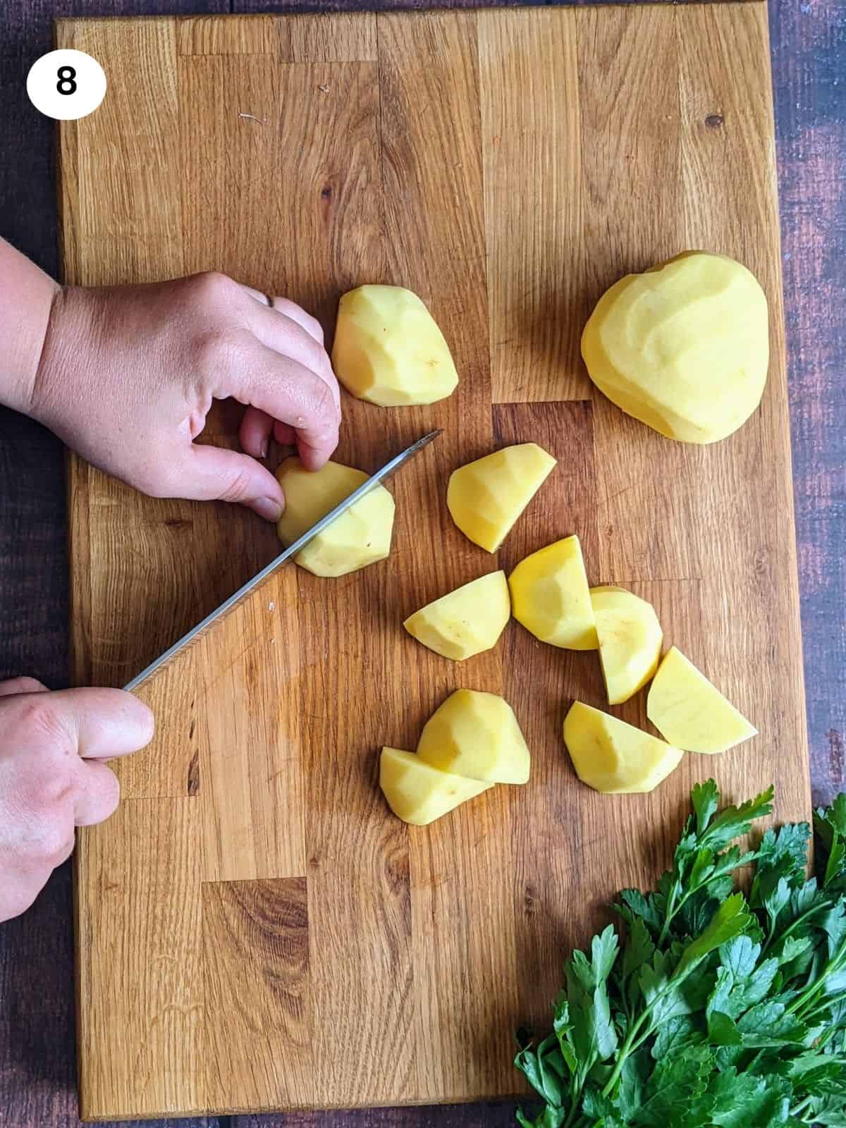 Cutting the potatoes into quarters.