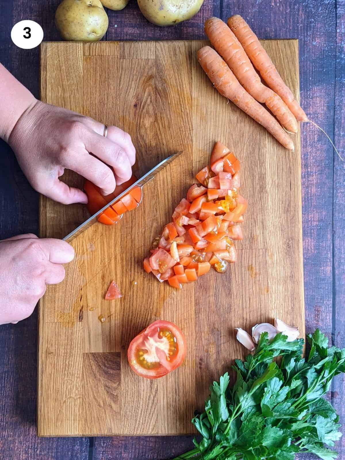 Cutting the tomatoes into big cubes.