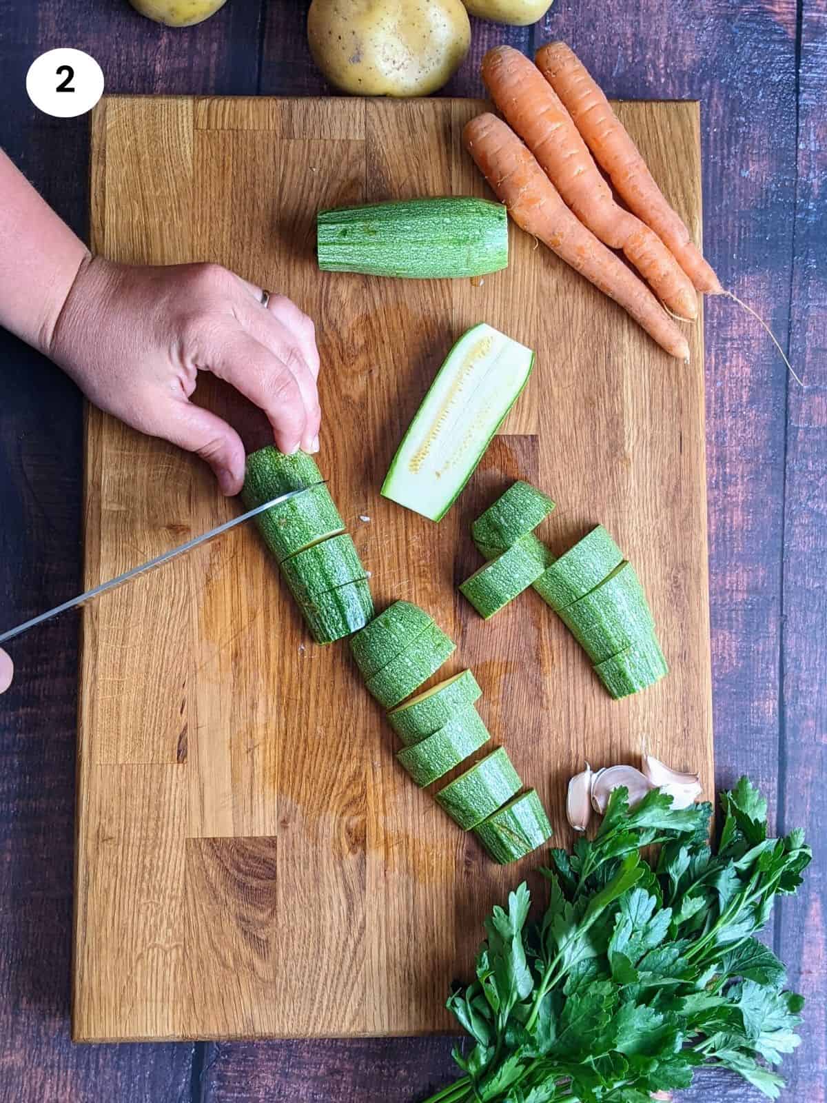 Cutting the zucchini into big chunks.