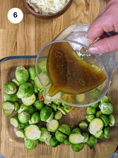 Adding the dressing for the roasted brussels sprouts.