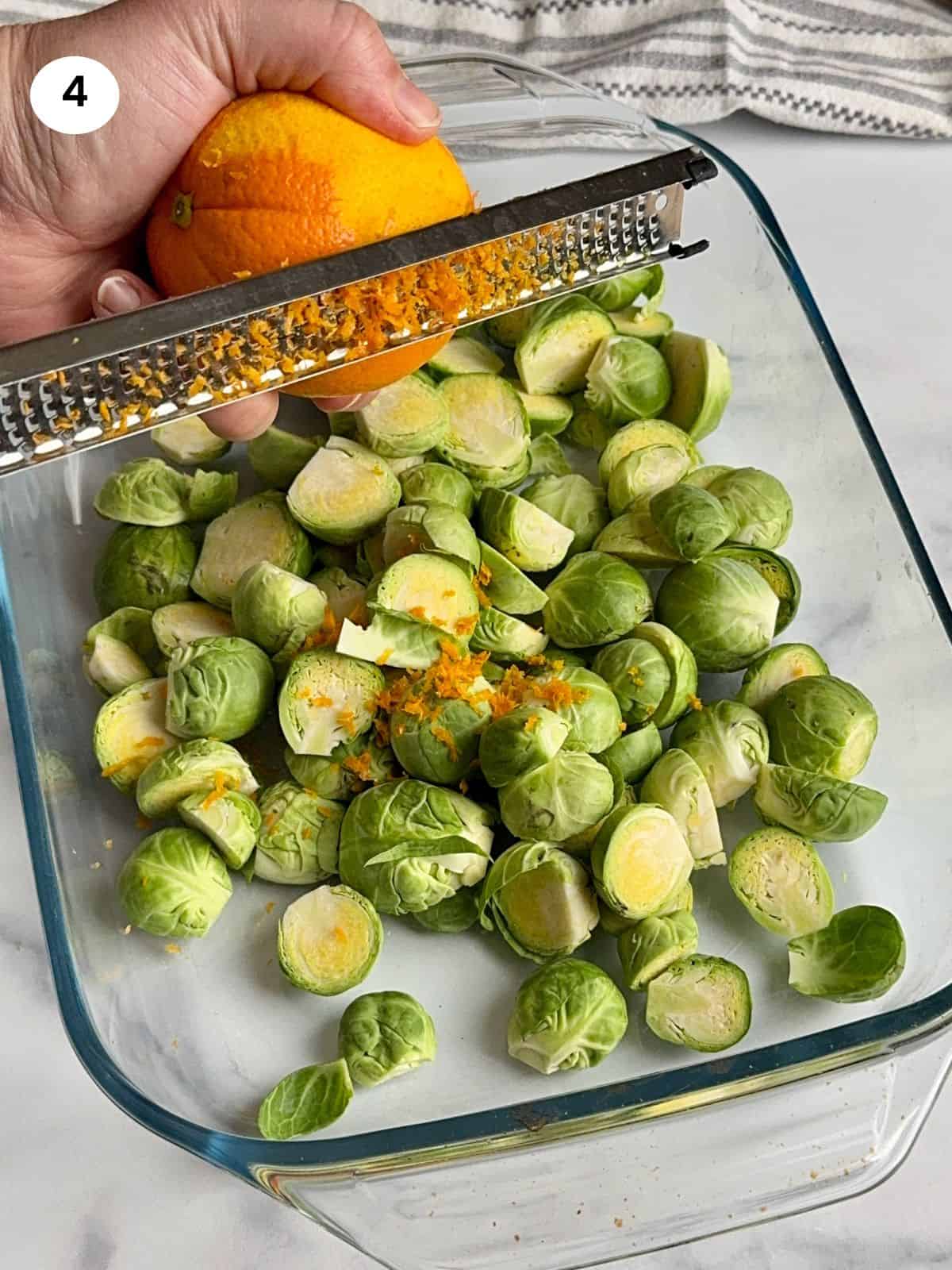 Adding the orange zest to the baking dish.