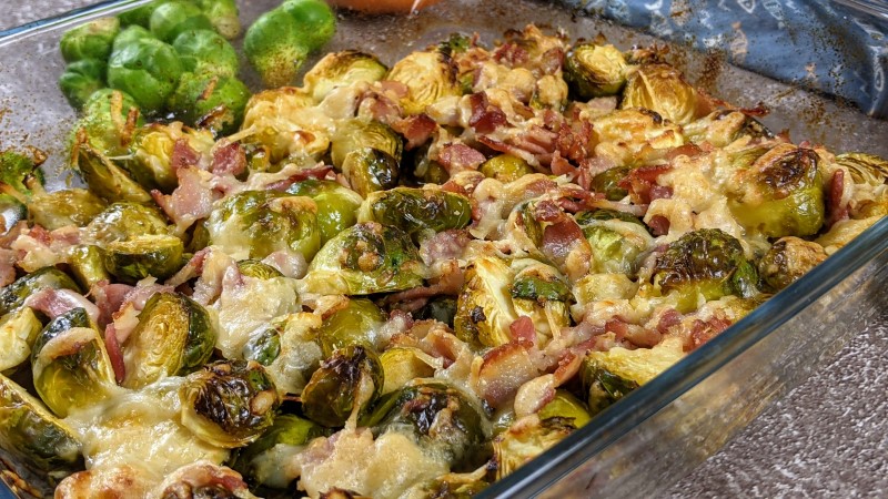 Roasted brussels sprouts with parmesan and bacon in the baking dish.