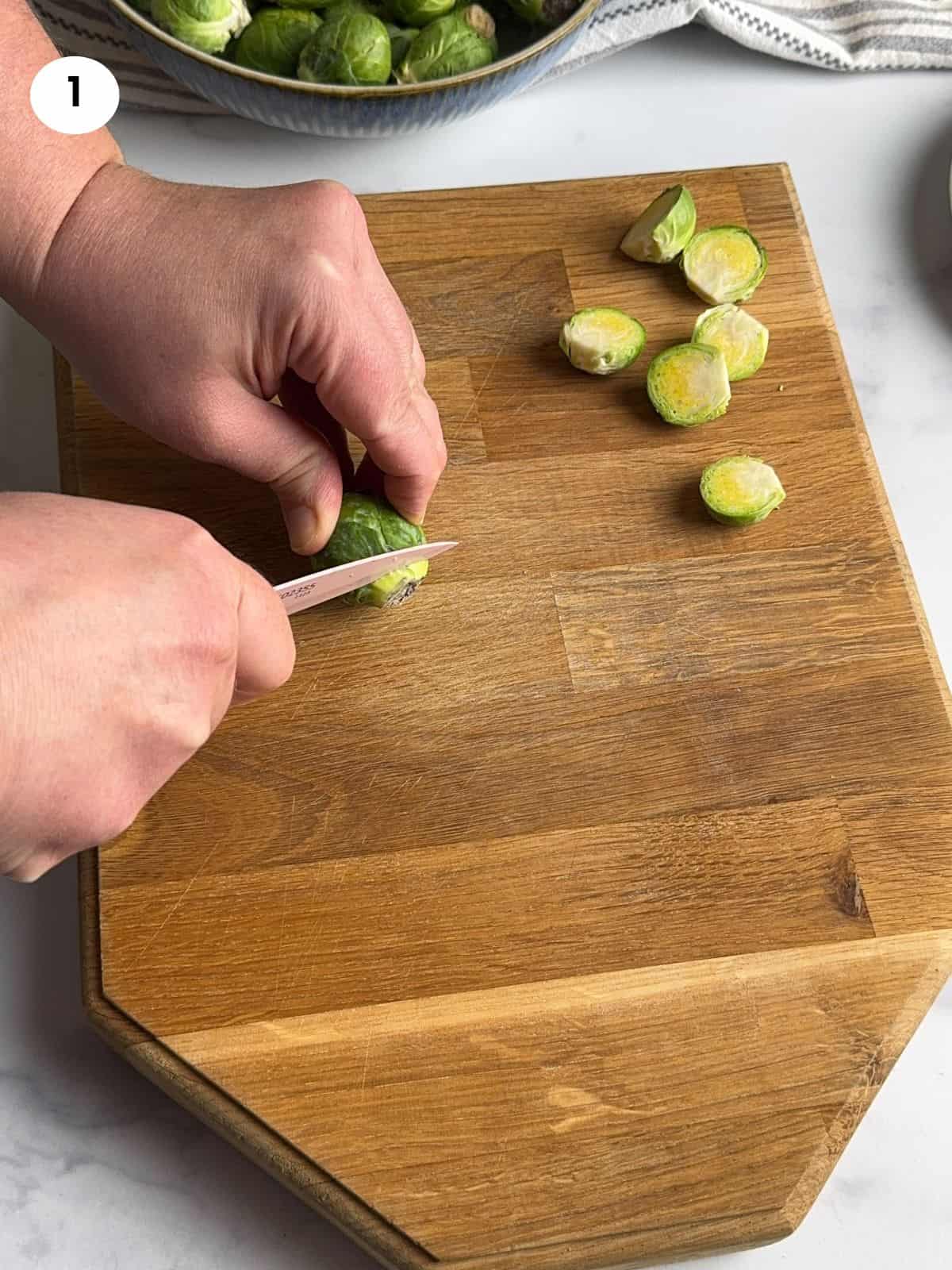 Cutting the brussels sprouts into half.