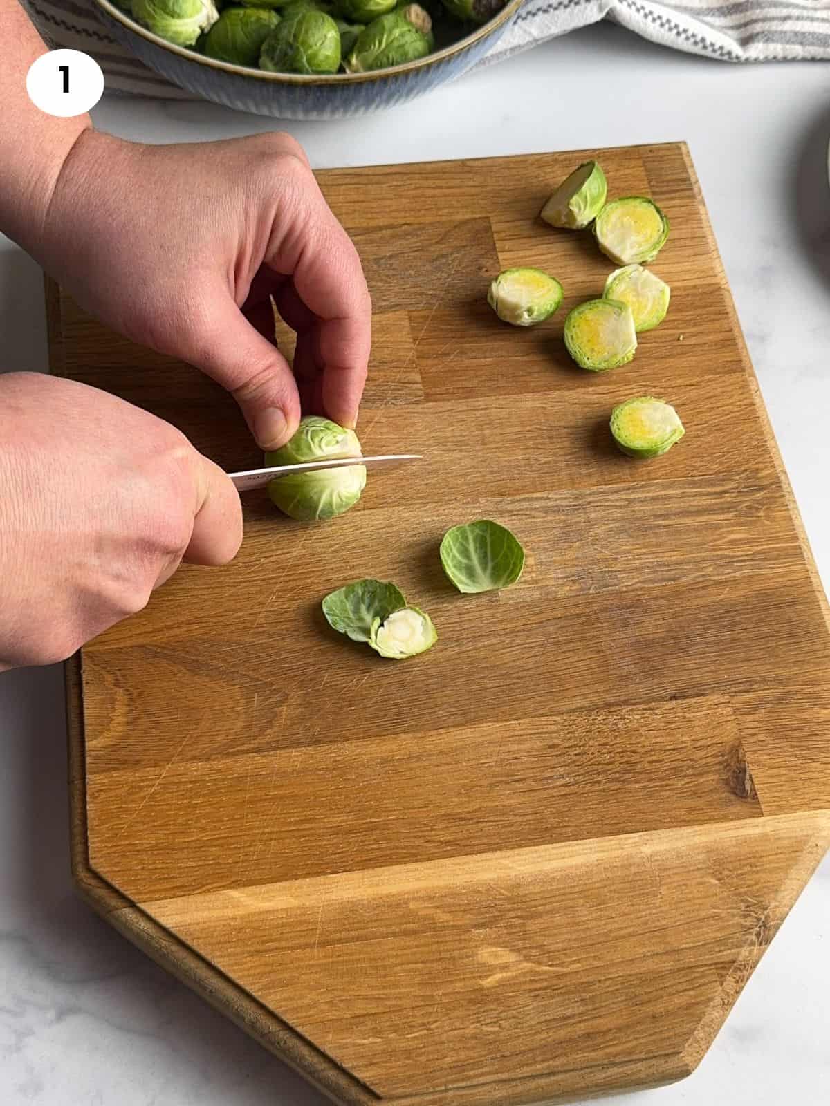 Cutting the brussels sprout in half.
