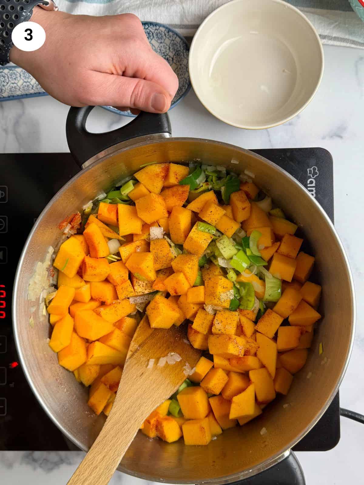 Added the squash cubes to the pot.