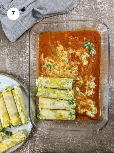 Adding the tomato sauce to the bottom of the ovenproof dish and placing the stuffed cannelloni on top.