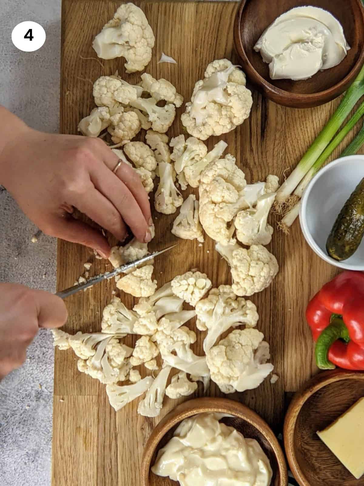 Cutting the cauliflower into small florets.