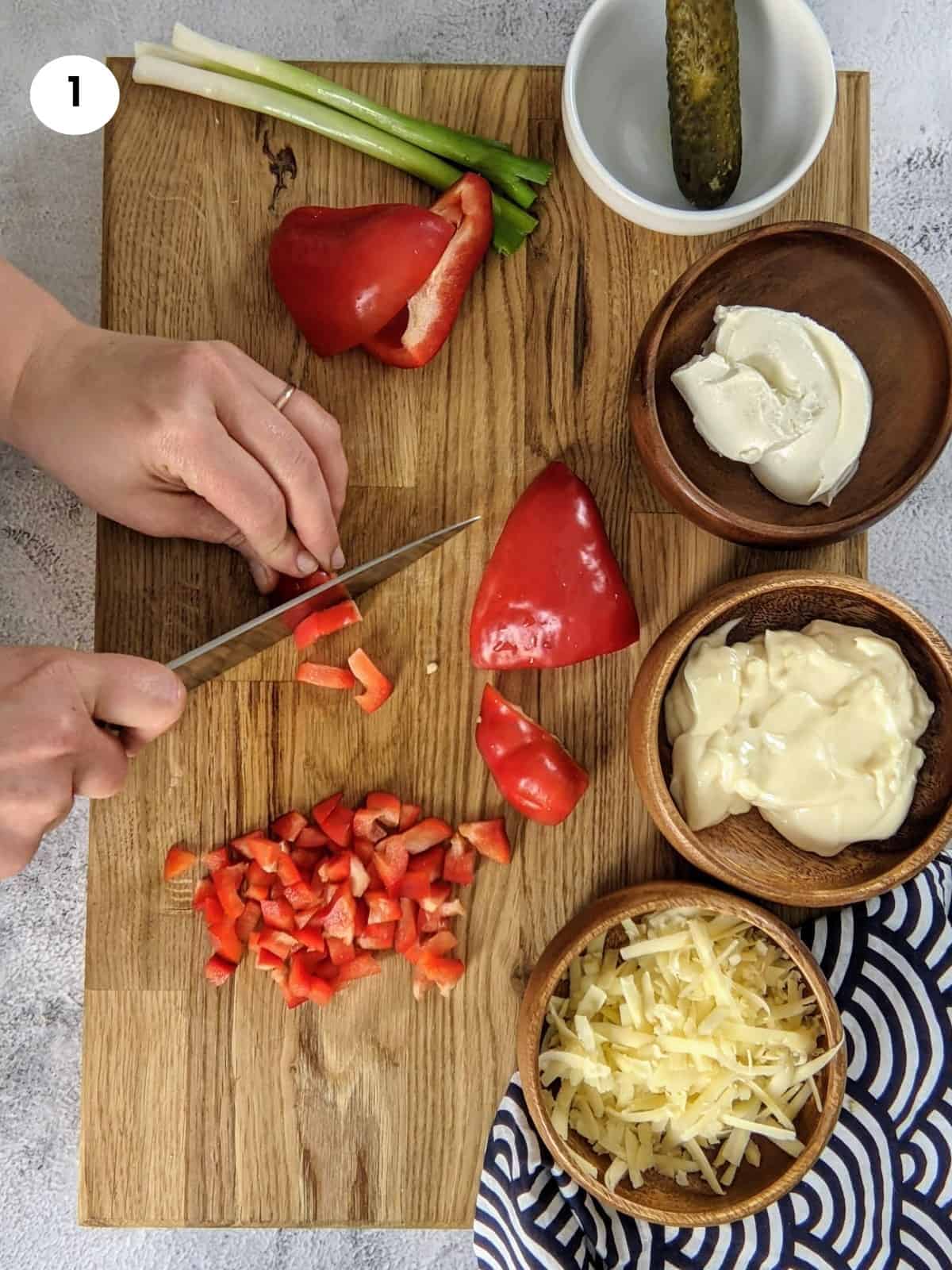 Cutting a bell pepper into cubes.