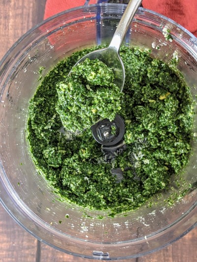 Blended ingredients into pesto sauce.