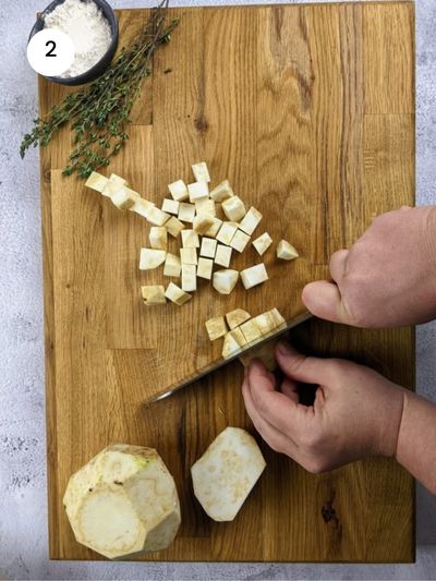 Cutting the celeriac into thick cubes.