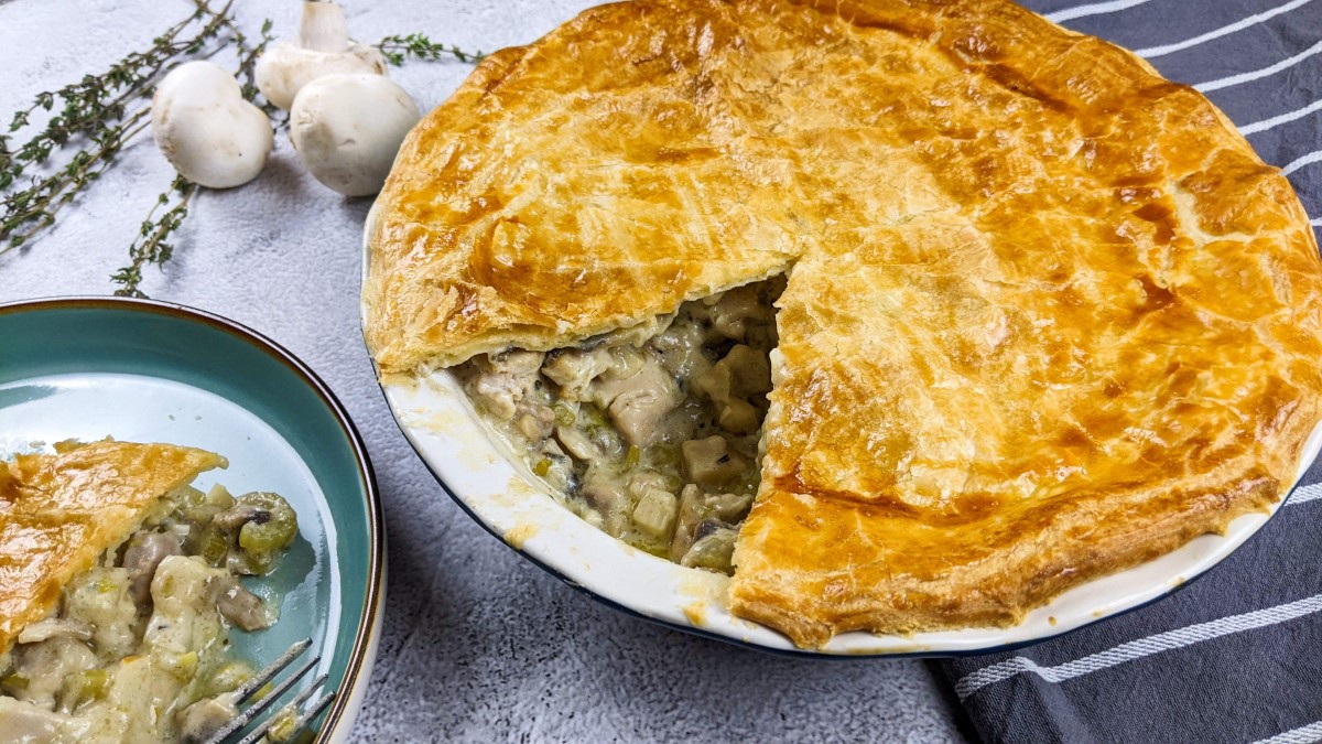 Celery, mushroom and chicken pie with one slice cut.