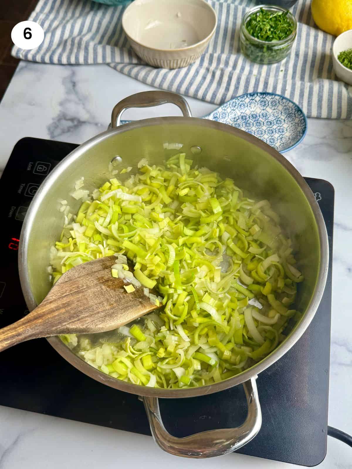 Cooking the leek slices.