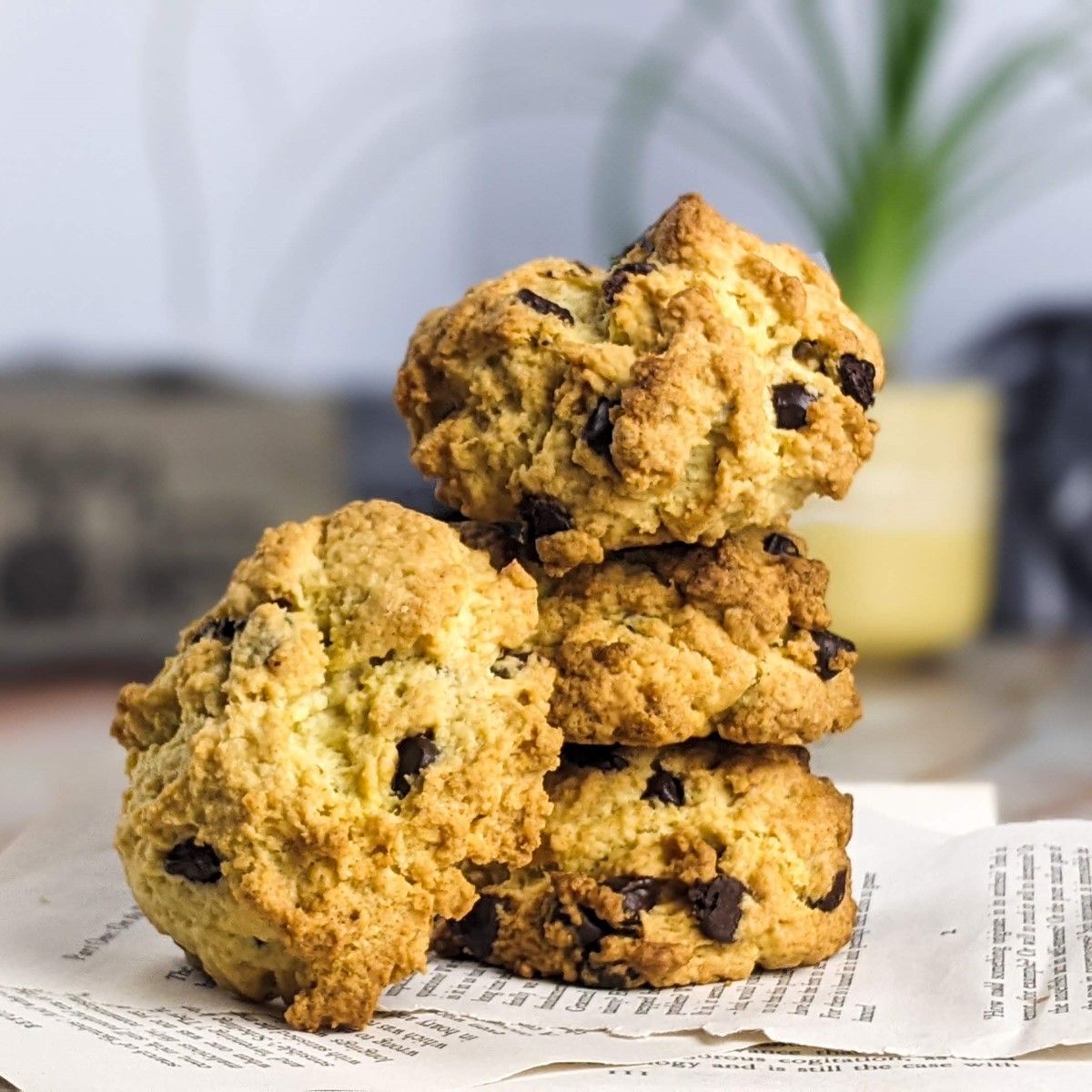 Stack of three chocolate chip rock cakes on top of book pages and one on the side.
