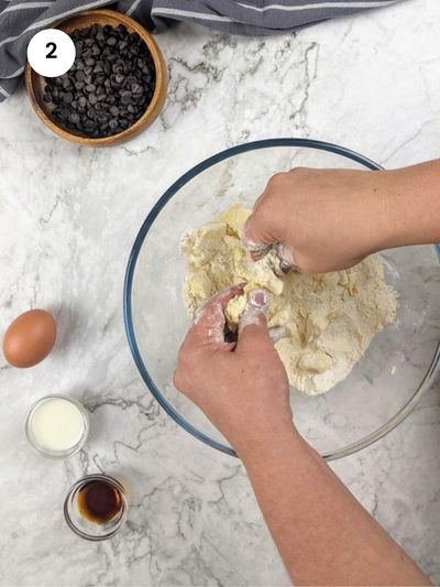 Rubbing the butter with the dry ingredients until it resembles breadcrumbs.