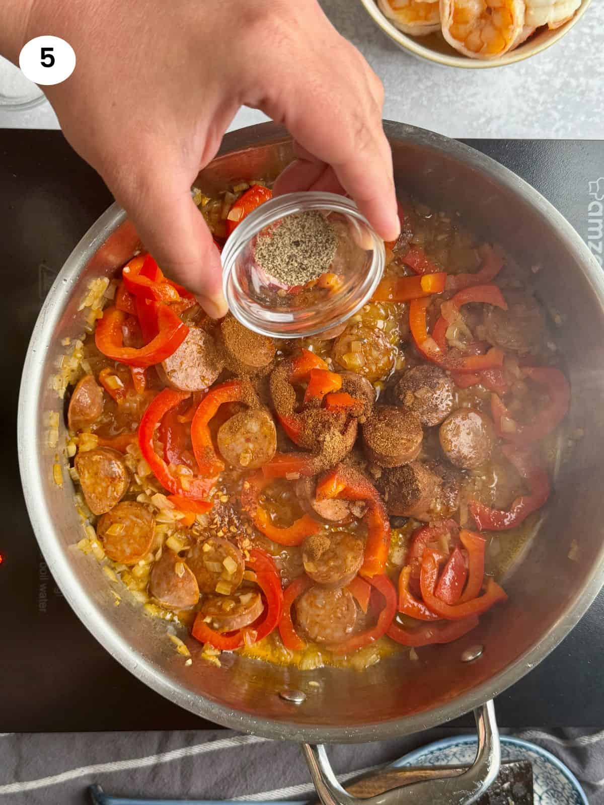 Adding the spices to the pan.
