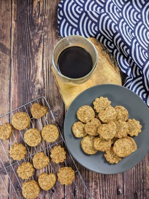 Stack of coconut-sugar cookies next to coffee and japanese waves tea towel Stack of coconut-sugar cookies next to coffee and japanese waves tea towel