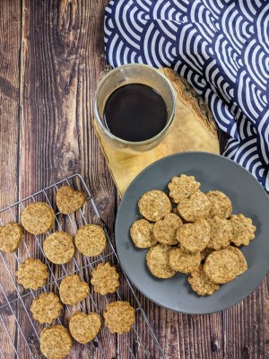 Stack of coconut-sugar cookies next to coffee and japanese waves tea towel