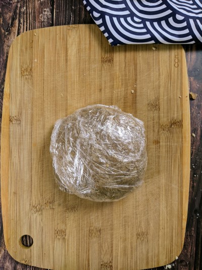 Dough for coconut sugar cookies in cling film.