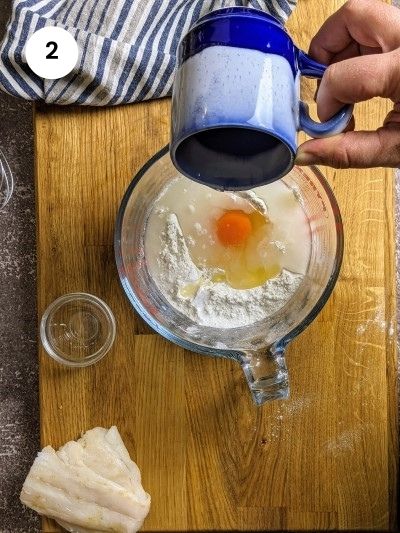 Adding water to flour and egg mixture.