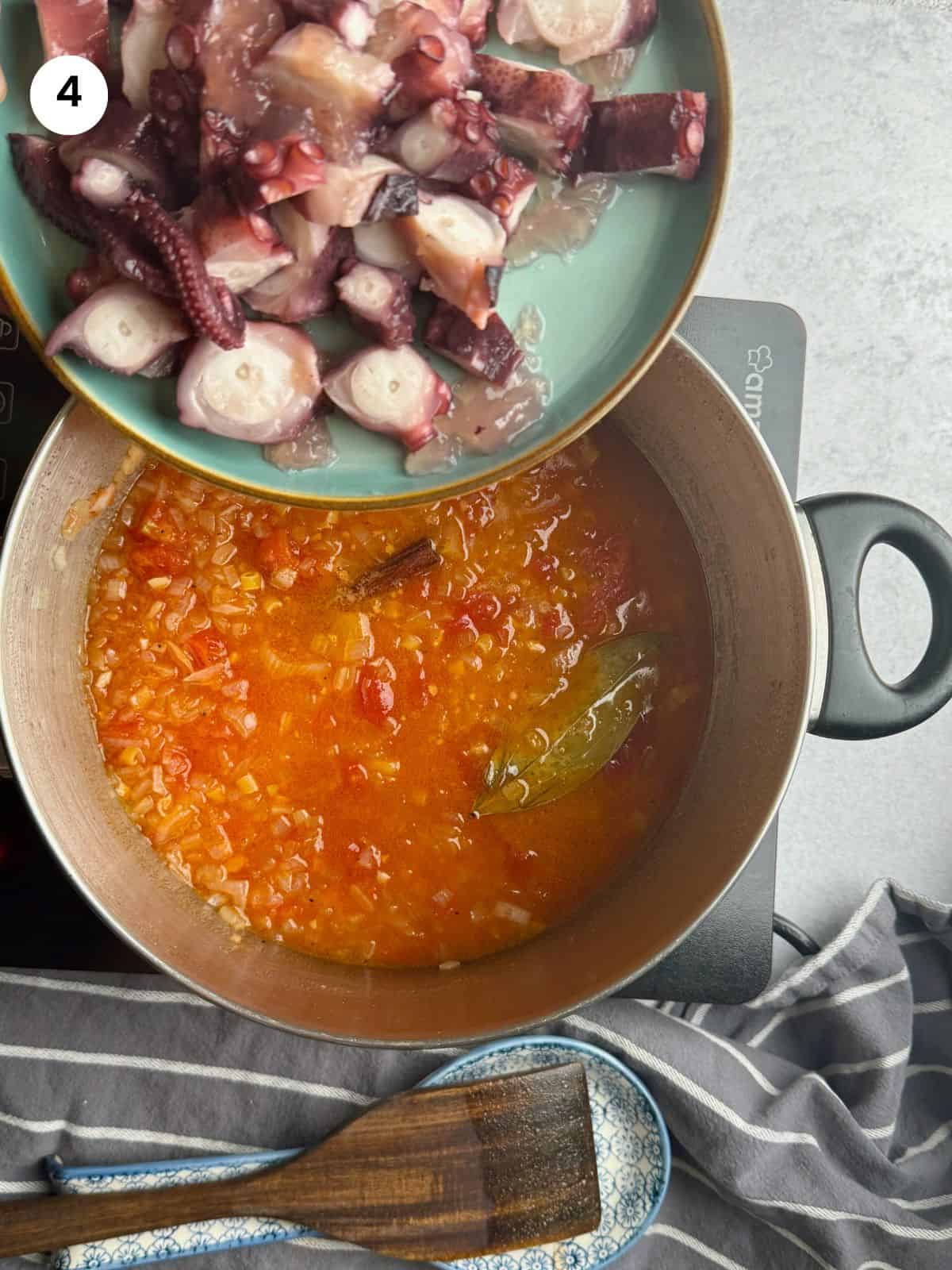 Adding the pasta and octopus to the pot.