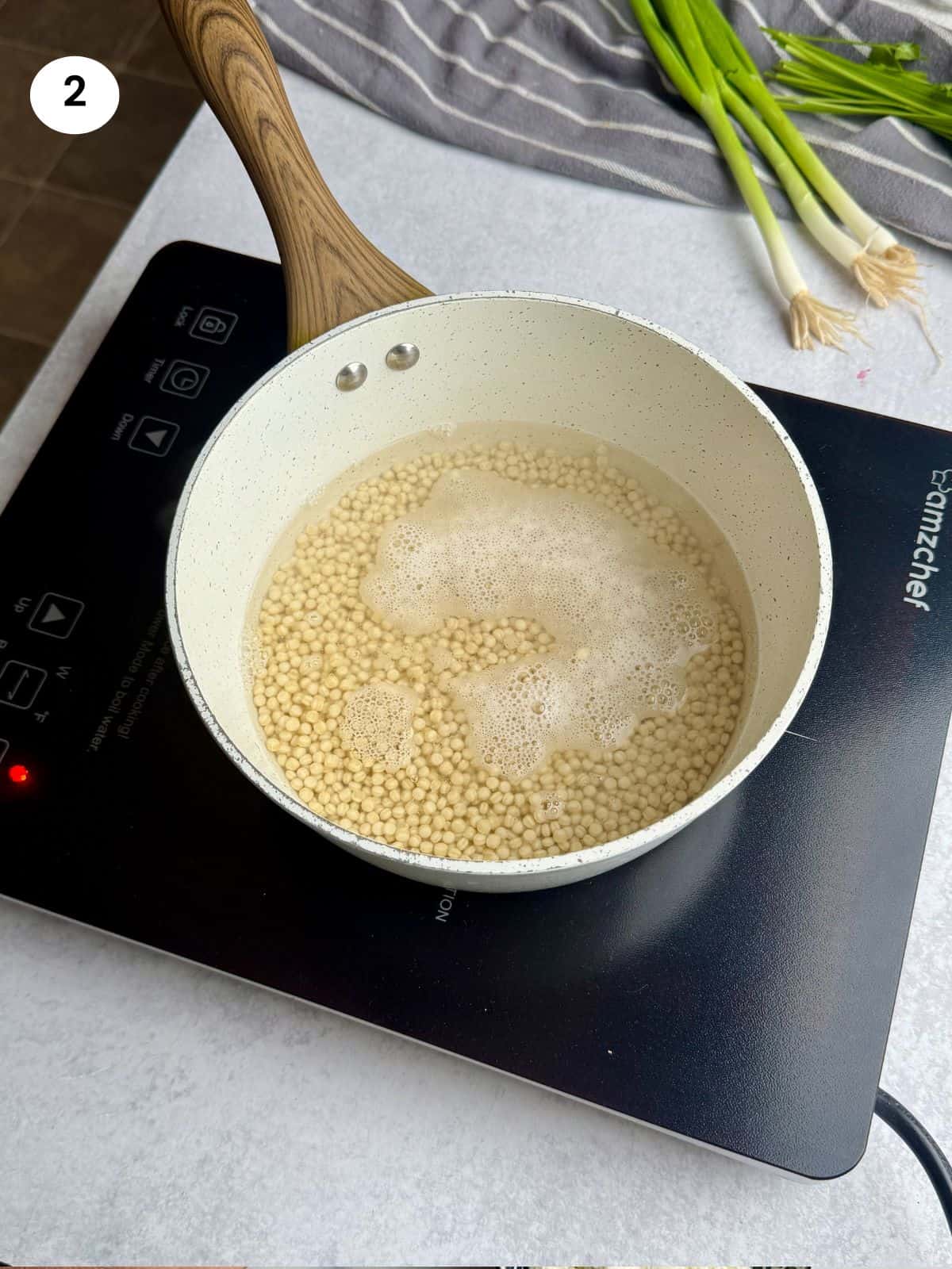 Cooking the pearl couscous in a pot.
